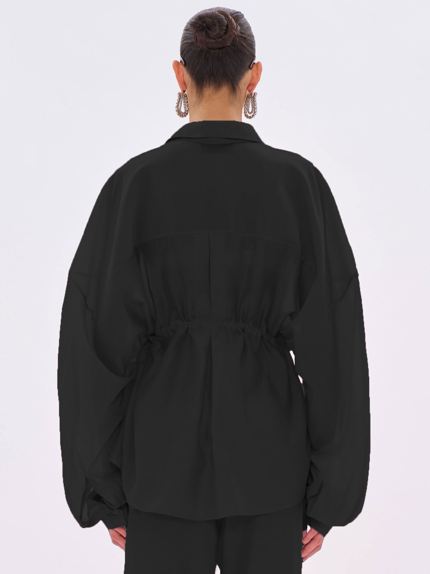 Person wearing a black jacket on a white background