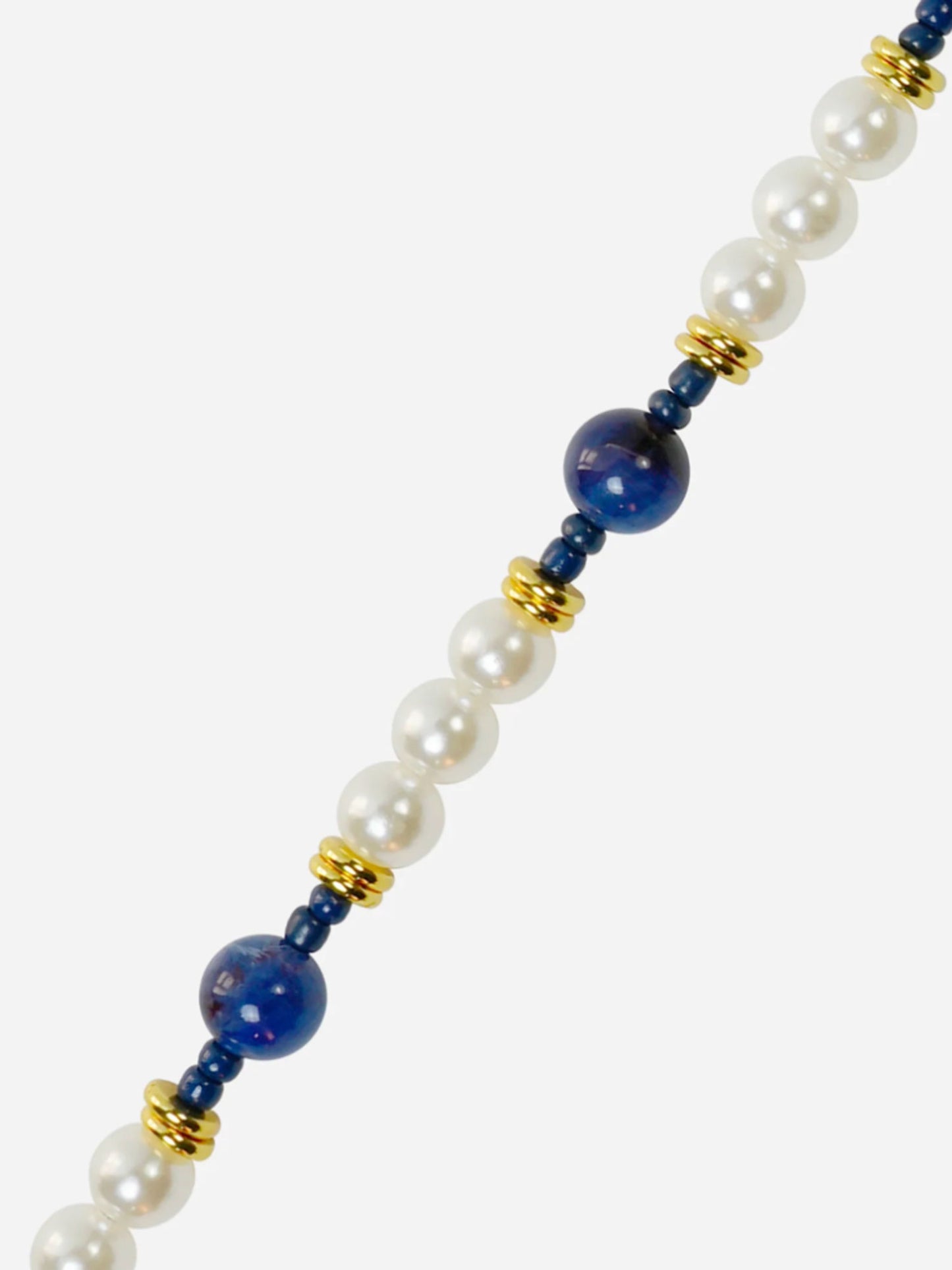 phone chain with white pearls, blue beads, and gold accents on a white background