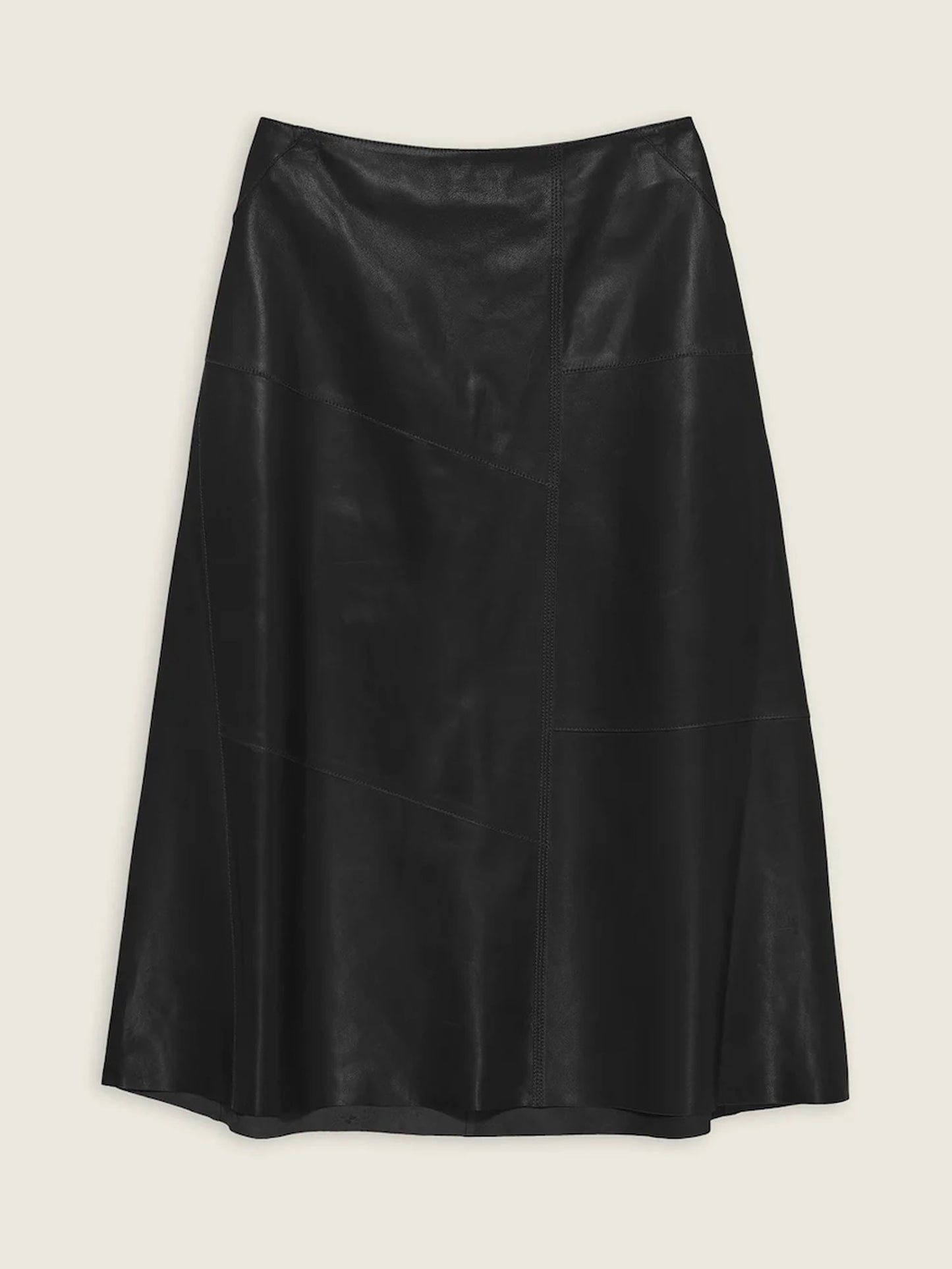 Black leather skirt on a light beige background
