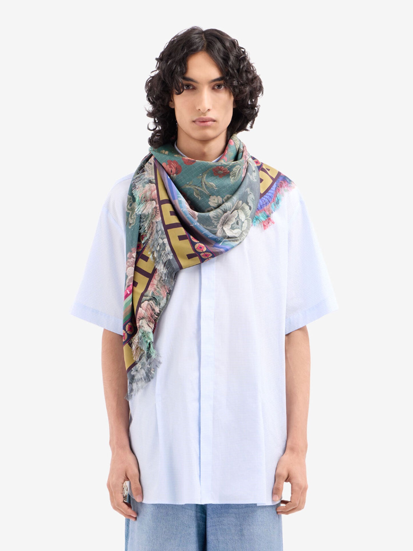Person wearing a colorful scarf on a white background