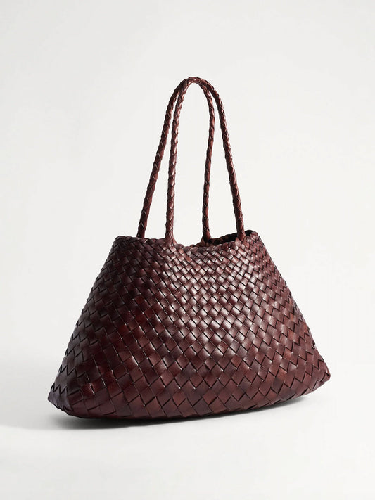 A dark reddish-brown woven leather tote bag with two braided shoulder straps, shown on a clean light gray background.