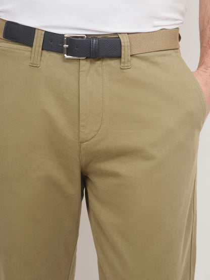Beige pants with a black belt on a plain background