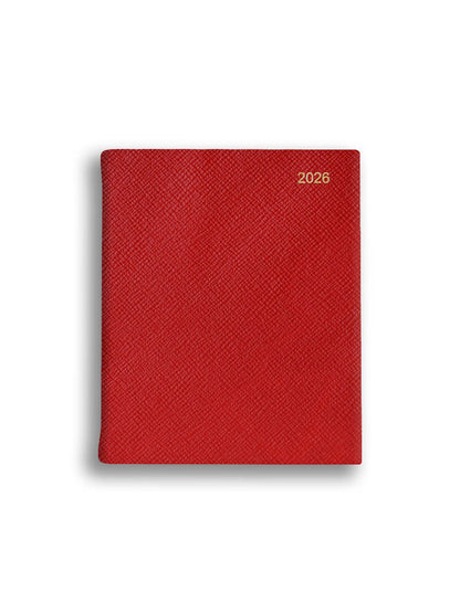 Red textured notebook with '2026' printed on a white background