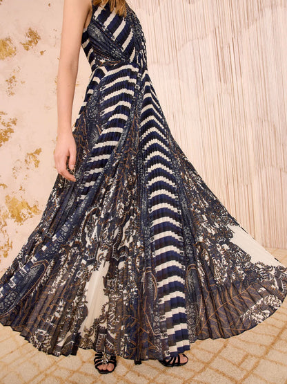 Long, patterned dress with a mix of dark and light colors on a textured surface.