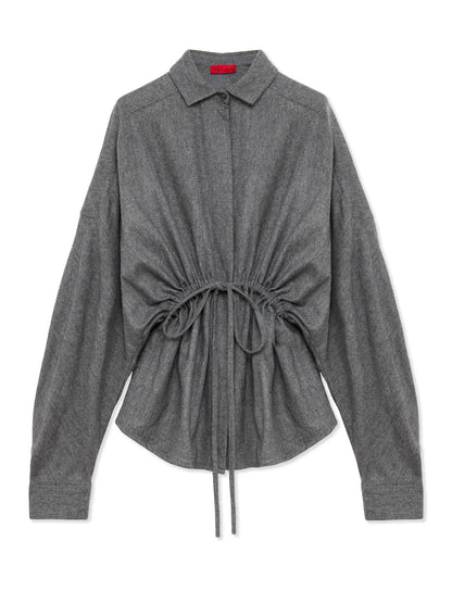 A dark gray long-sleeve shirt with a pointed collar, button-down front, and a drawstring detail at the waist, displayed on a clean white background.