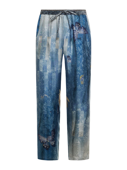 Blue silk pants with butterfly designs on a white background