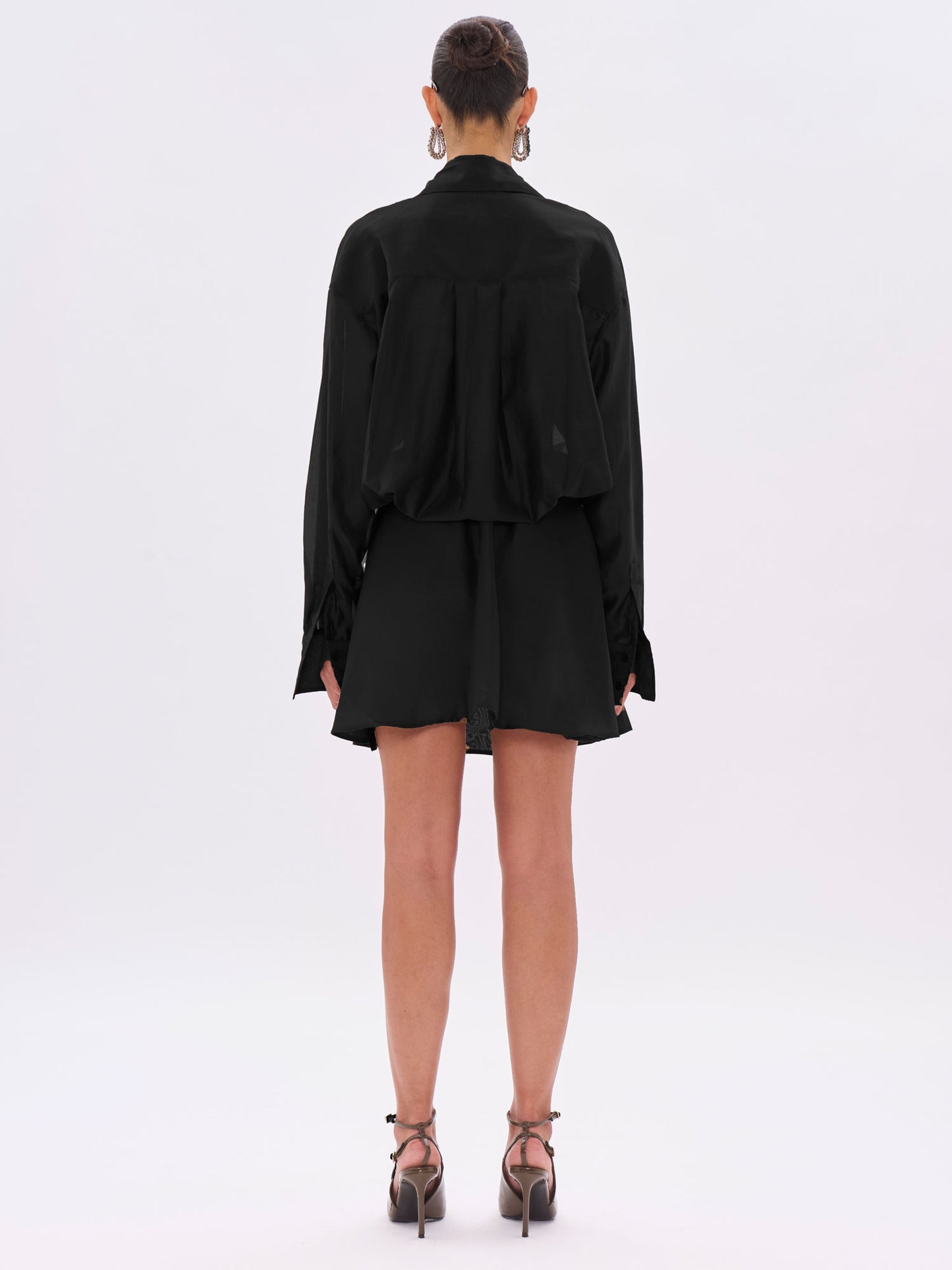 Person wearing a black outfit on a white background