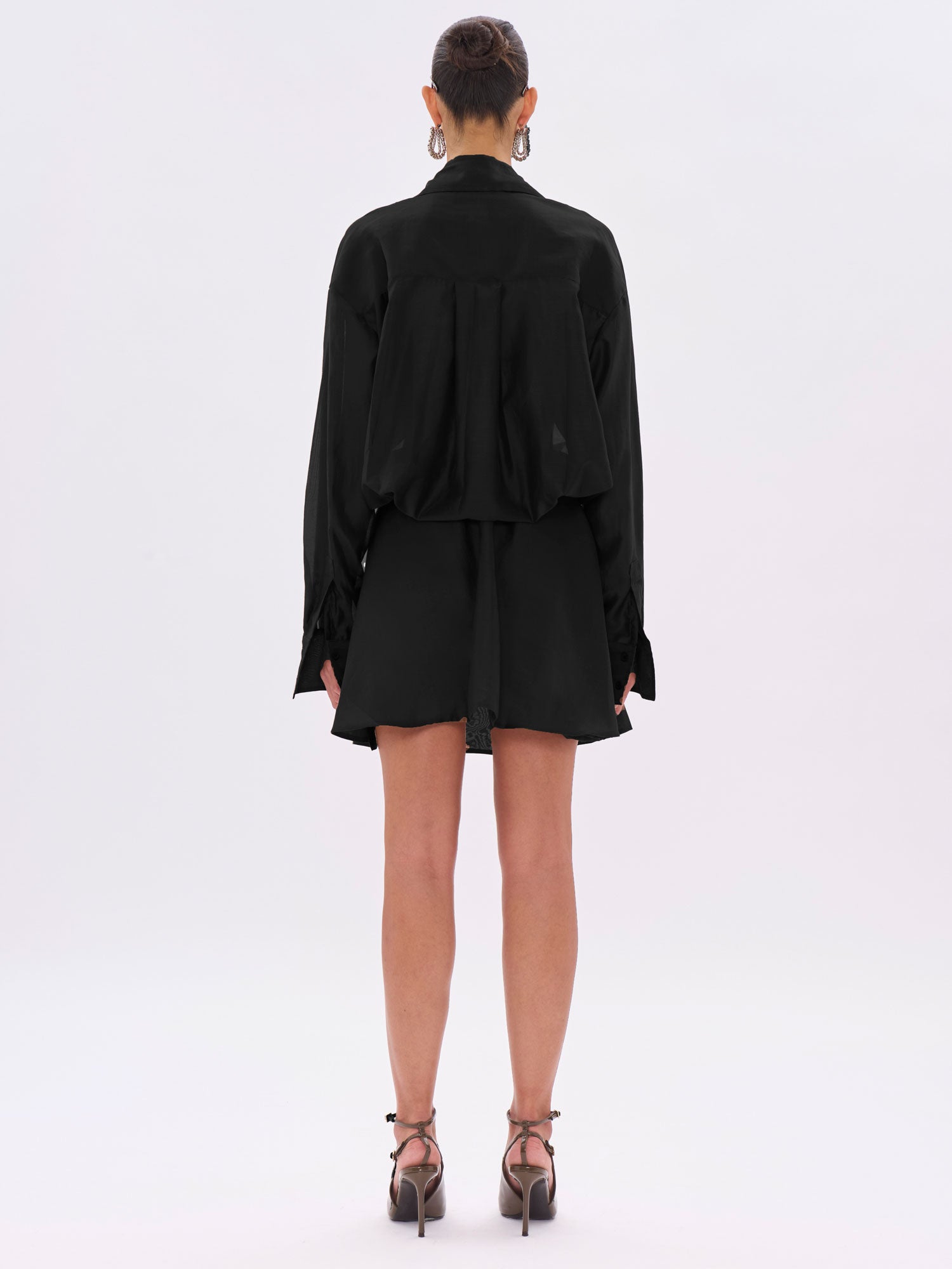 Person wearing a black outfit on a white background