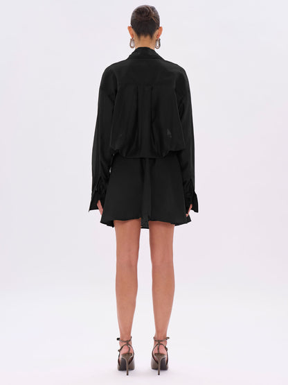 Person wearing a black outfit on a white background