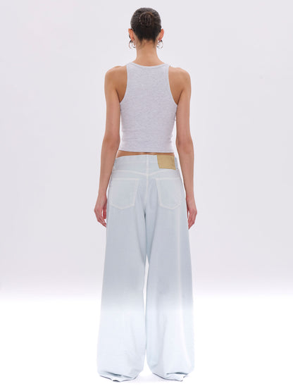 Person wearing a light gray tank top and wide-leg pants on a white background