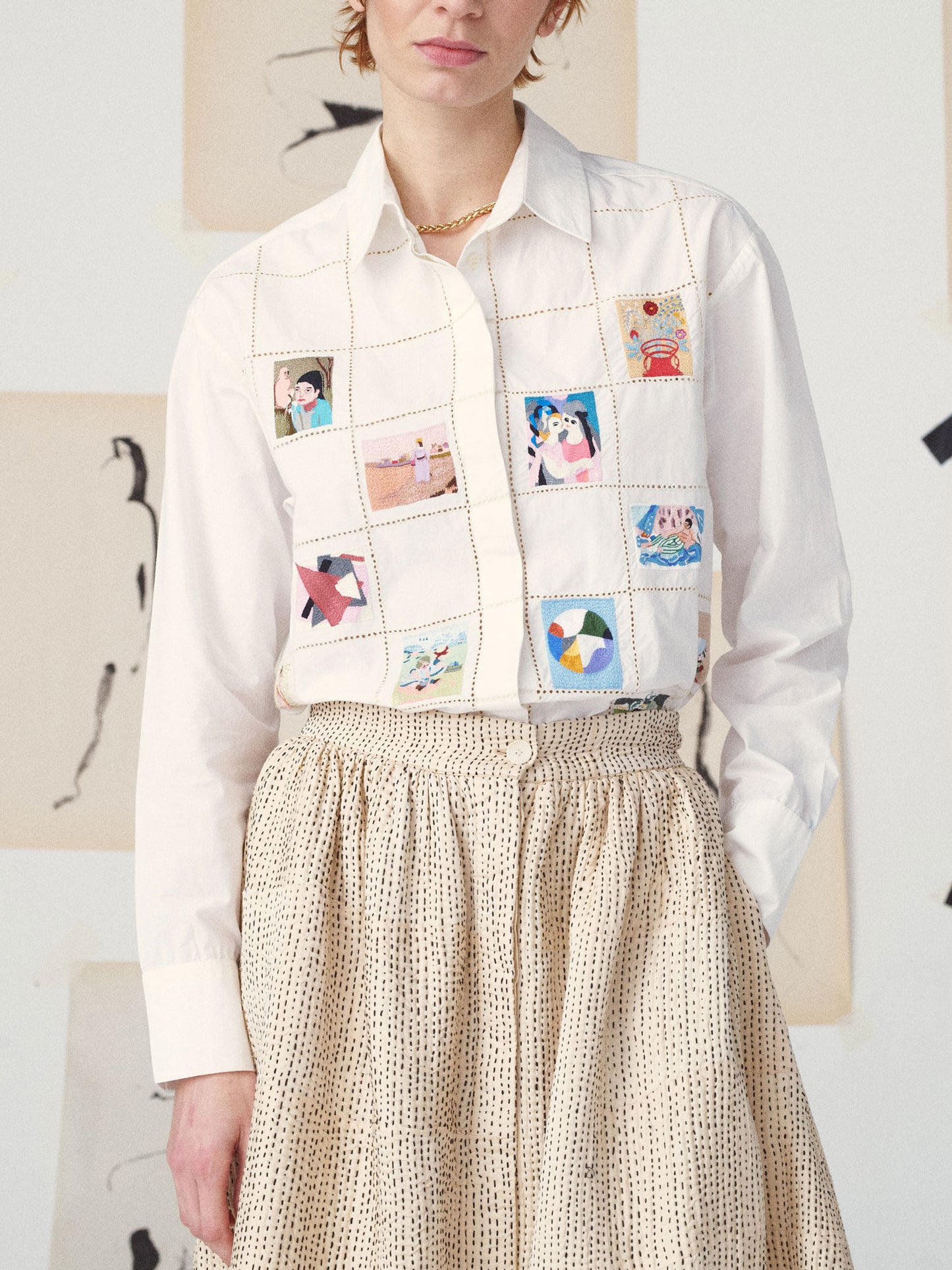 Person wearing a white shirt with a colorful patchwork vest over a beige skirt.