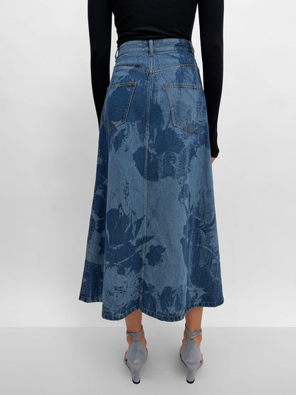 Blue floral-patterned skirt worn by a person on a white background