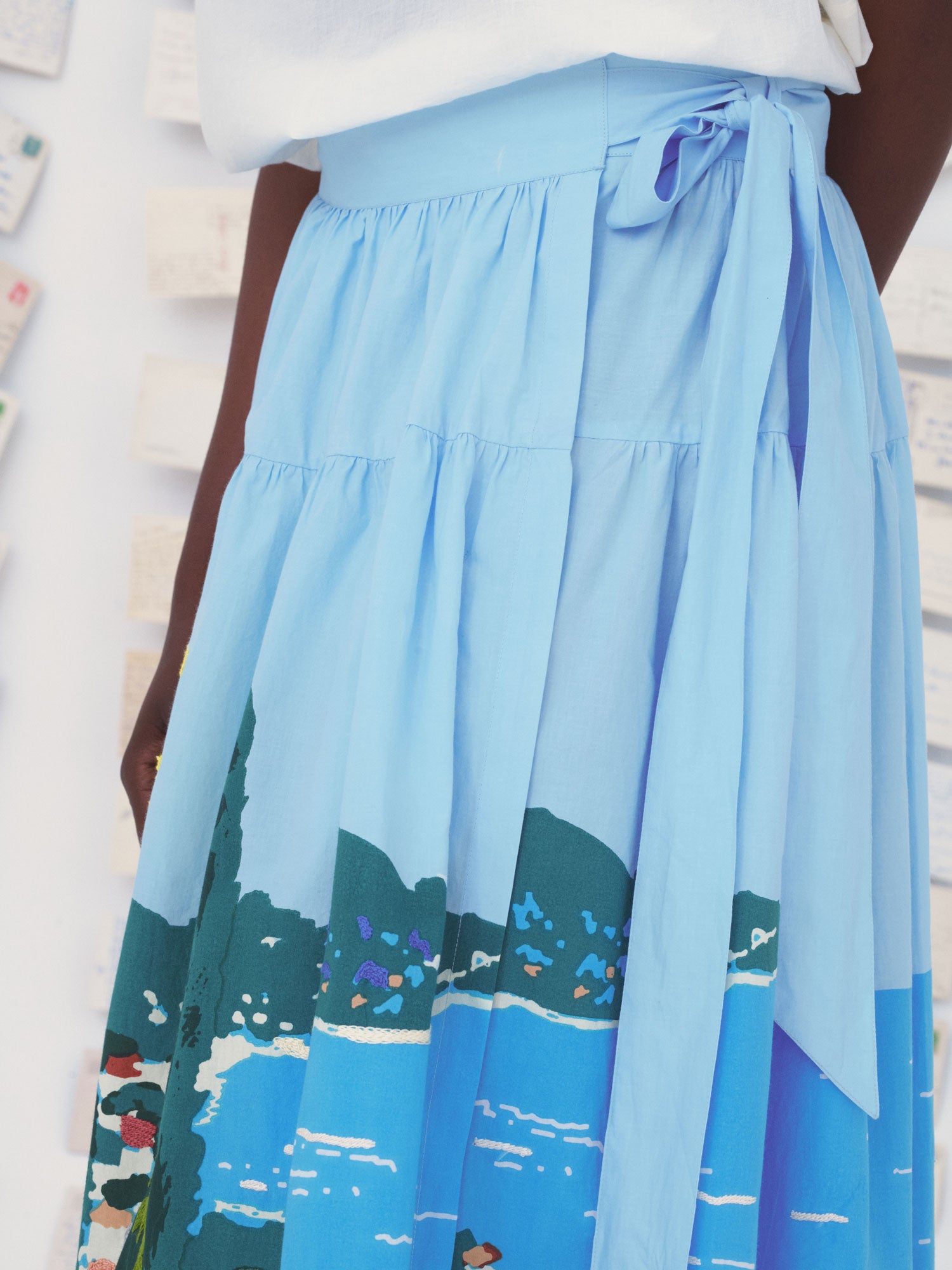 Blue Mii skirt with a scenic print on a white background