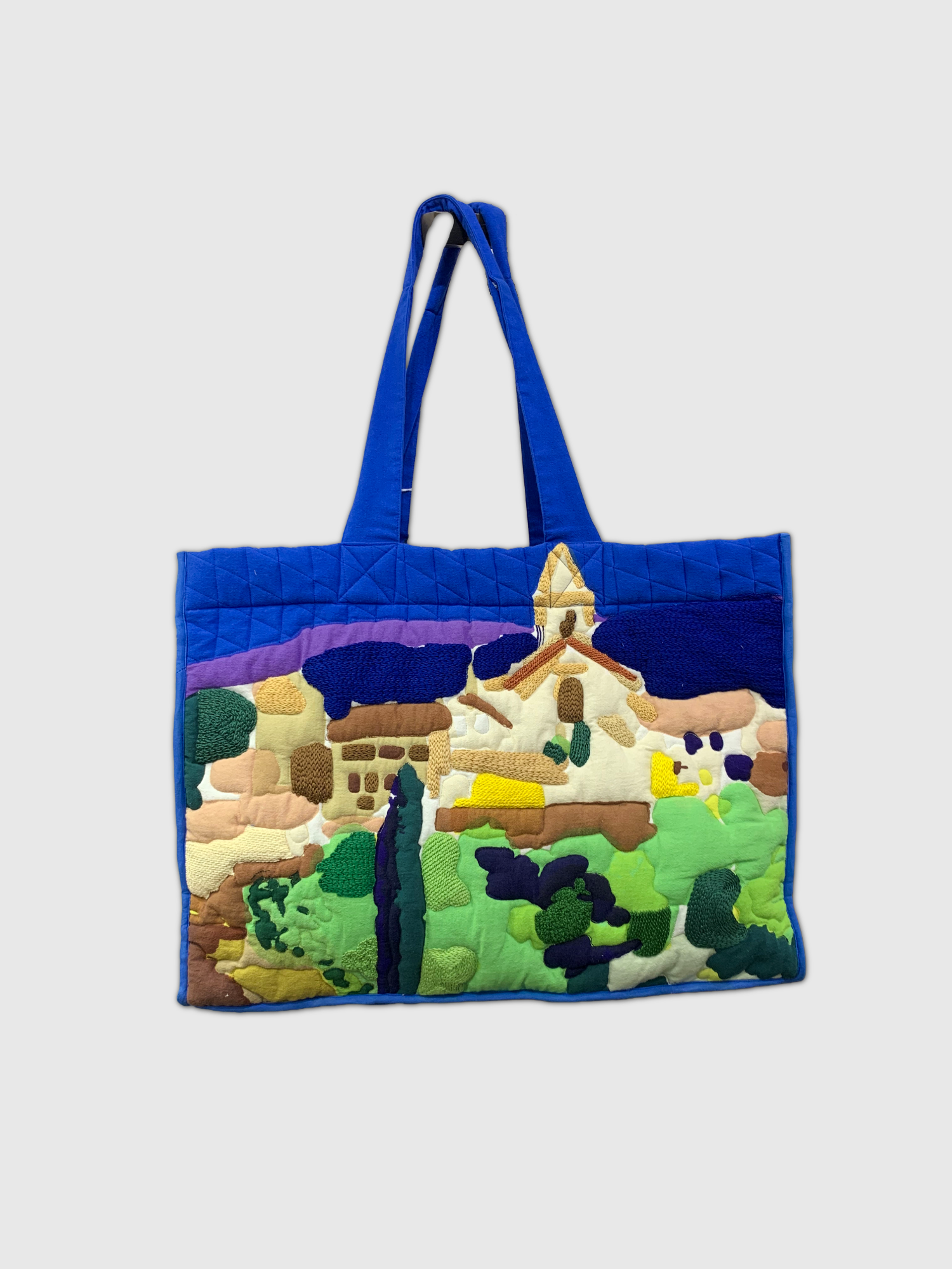 Tote bag with a colorful landscape design on a white background