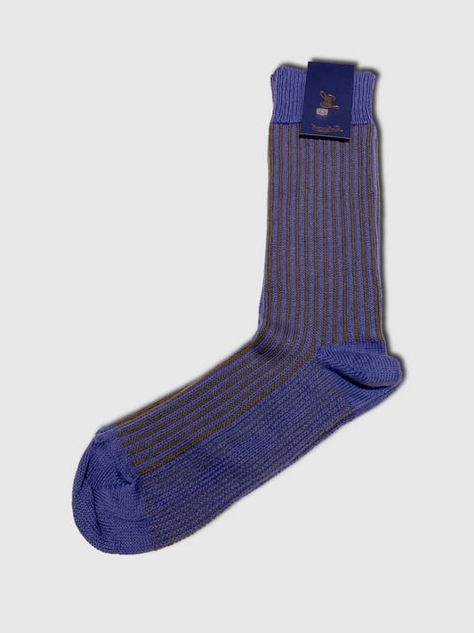 Blue striped sock with packaging on a light gray background