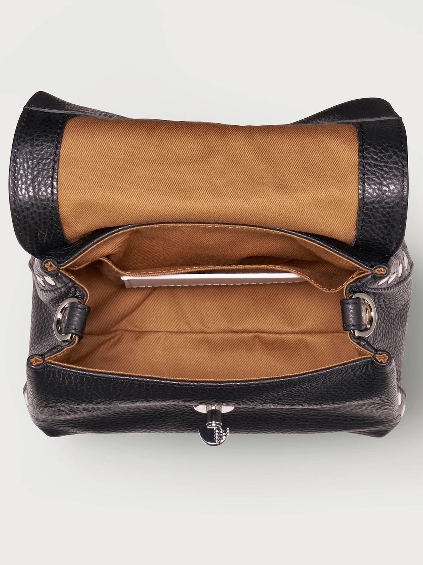 Black leather handbag with brown interior on a white background