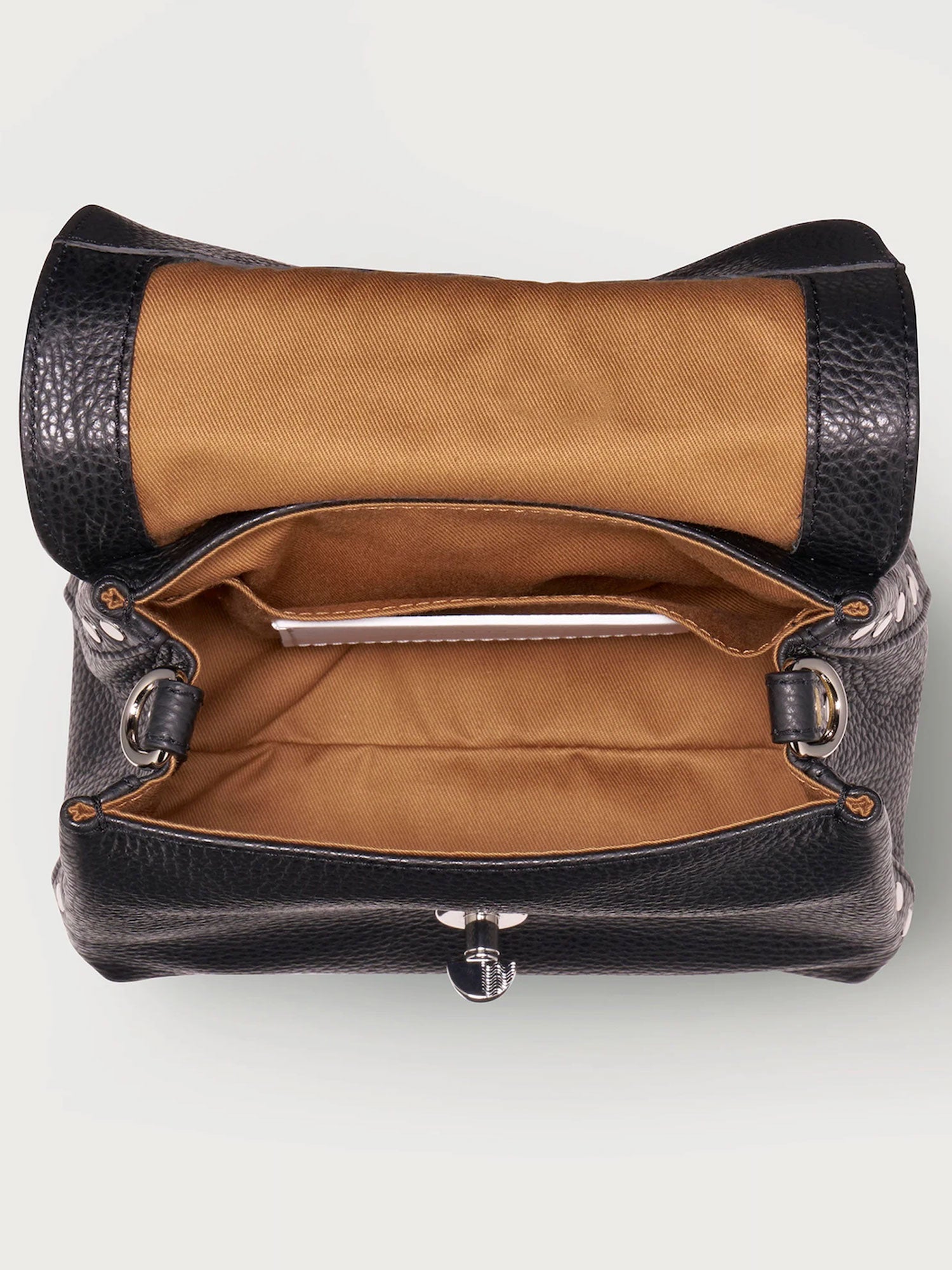 Black leather handbag with brown interior on a white background