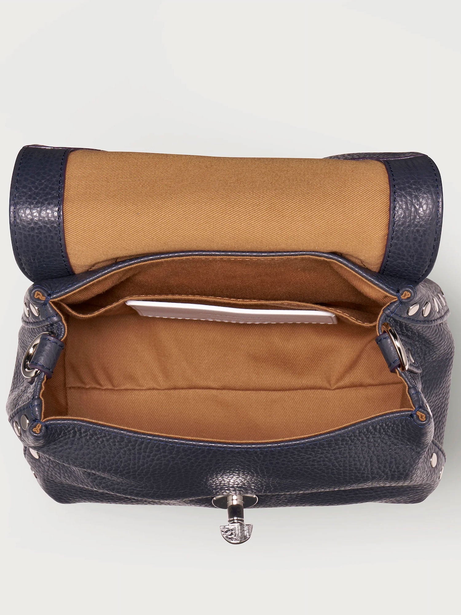 Brown and navy handbag with open front pocket on a white background