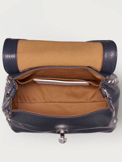 Brown and navy handbag with open front pocket on a white background