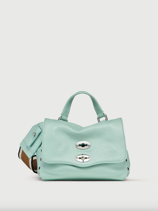 Light bue handbag with a silver buckle on a light gray background