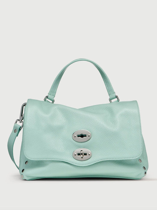Light blue handbag with silver buckle on a light gray background