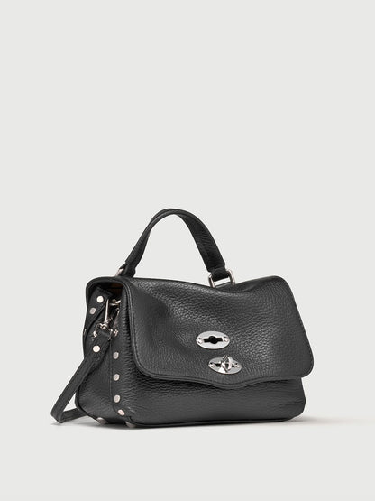 Black handbag with silver accents on a light gray background