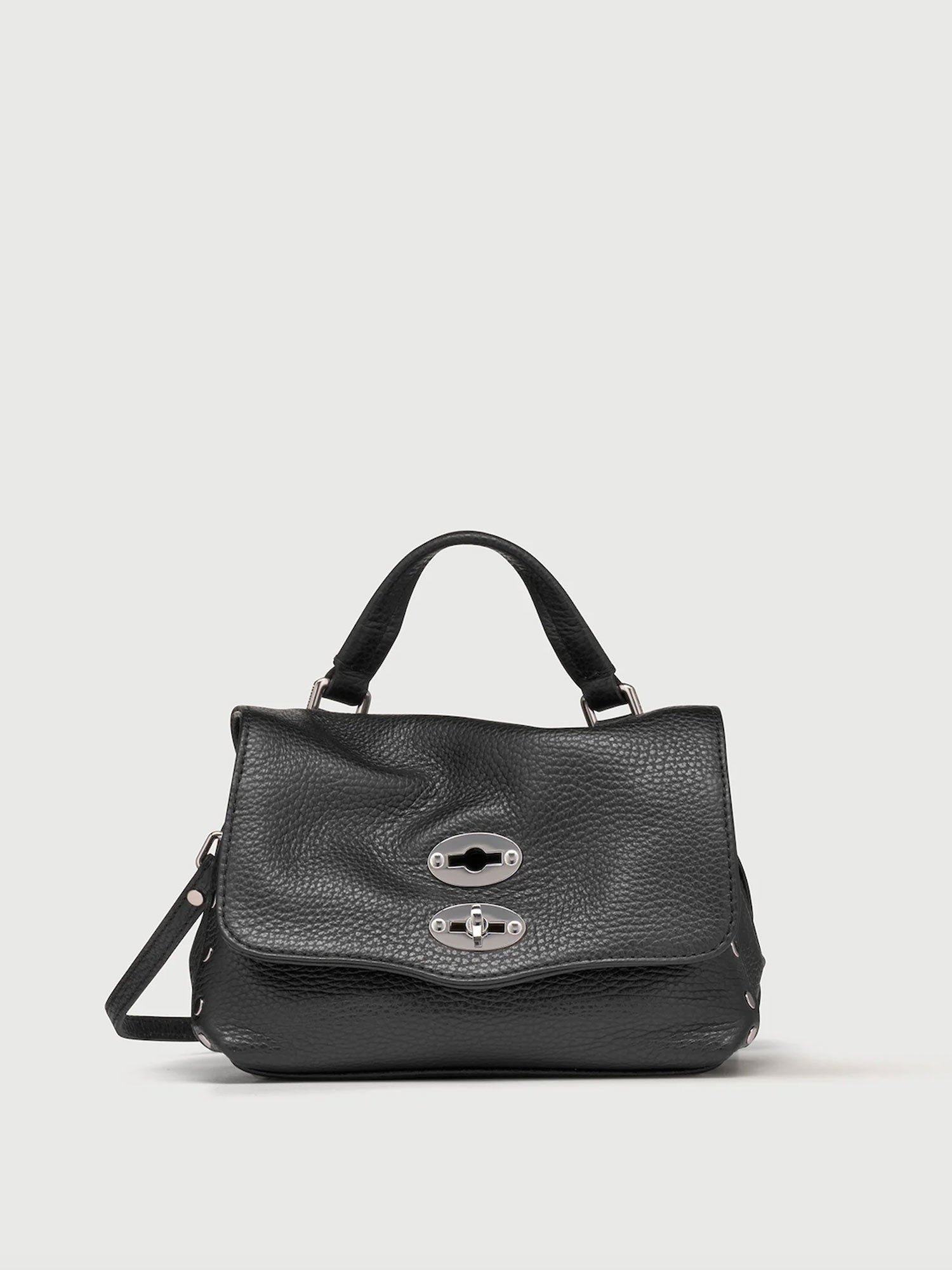 Black handbag with silver clasp on a light gray background
