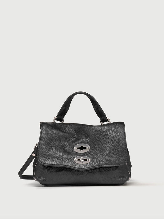 Black handbag with silver clasp on a light gray background