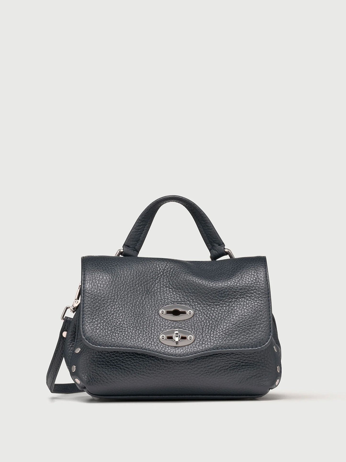 Dark navy handbag with a silver clasp on a light gray background