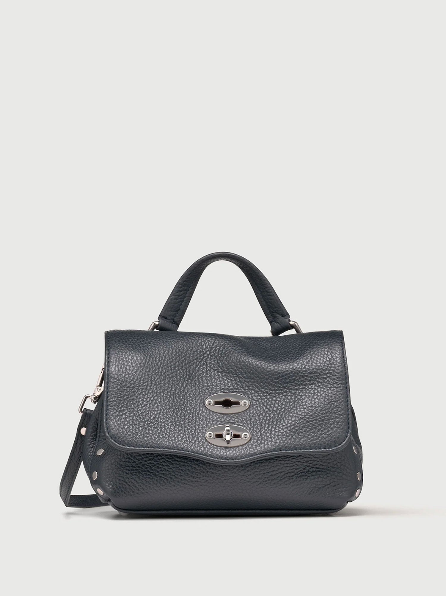 Dark navy handbag with a silver clasp on a light gray background