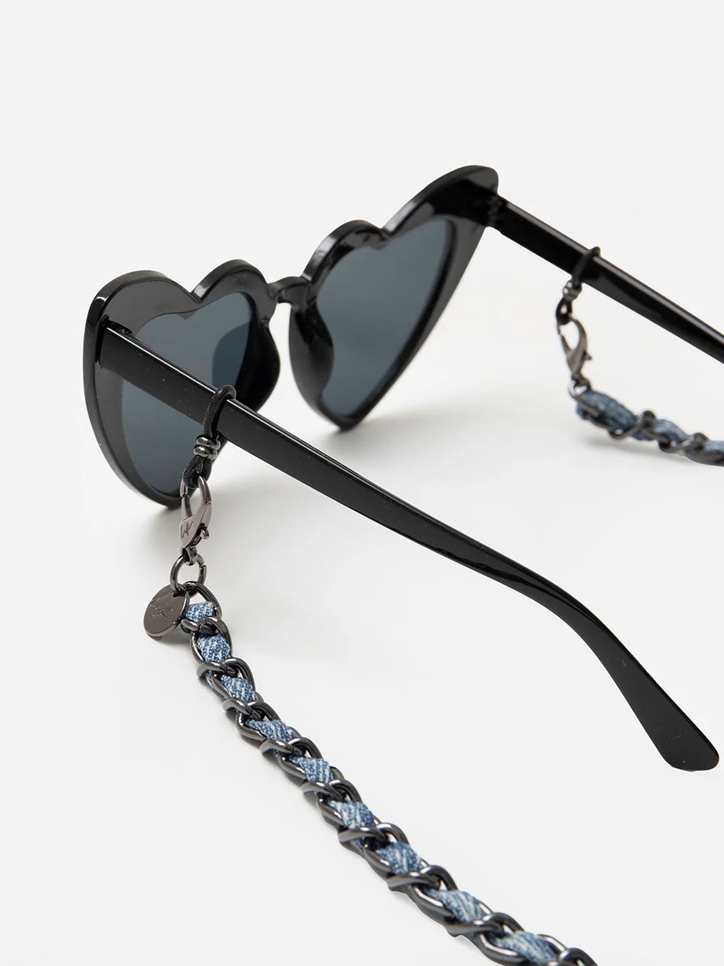 Black heart-shaped sunglasses with a chain strap on a white background