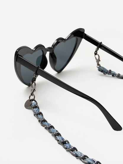 Black heart-shaped sunglasses with a chain strap on a white background