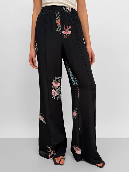 black silk pants with floral motifs