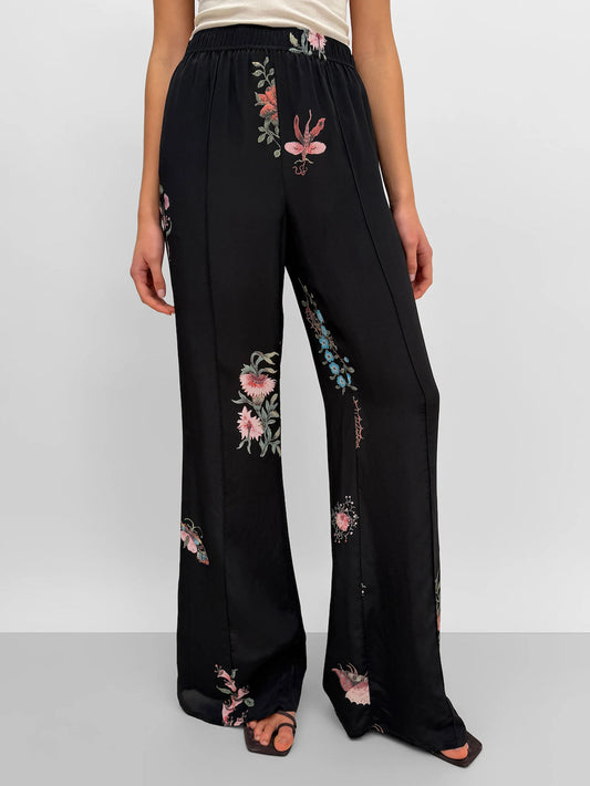 black silk pants with floral motifs