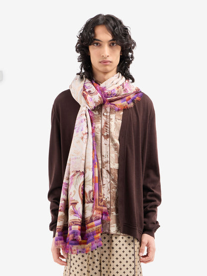 Person wearing a patterned scarf on a white background