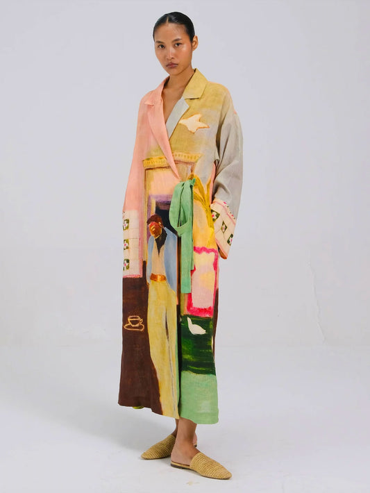 Woman wearing a colorful, patterned dress with a white background