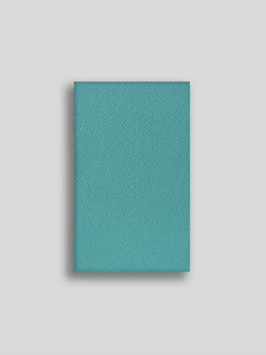 Teal textured notebook on a light gray background