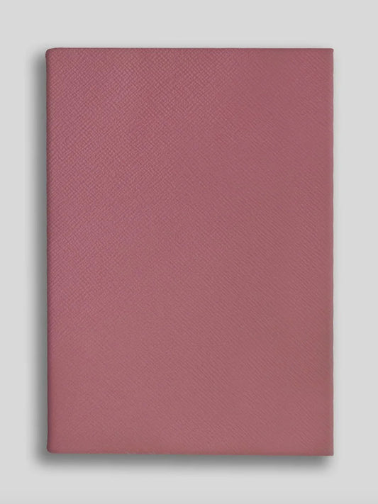 Rose textured notebook on a light gray background