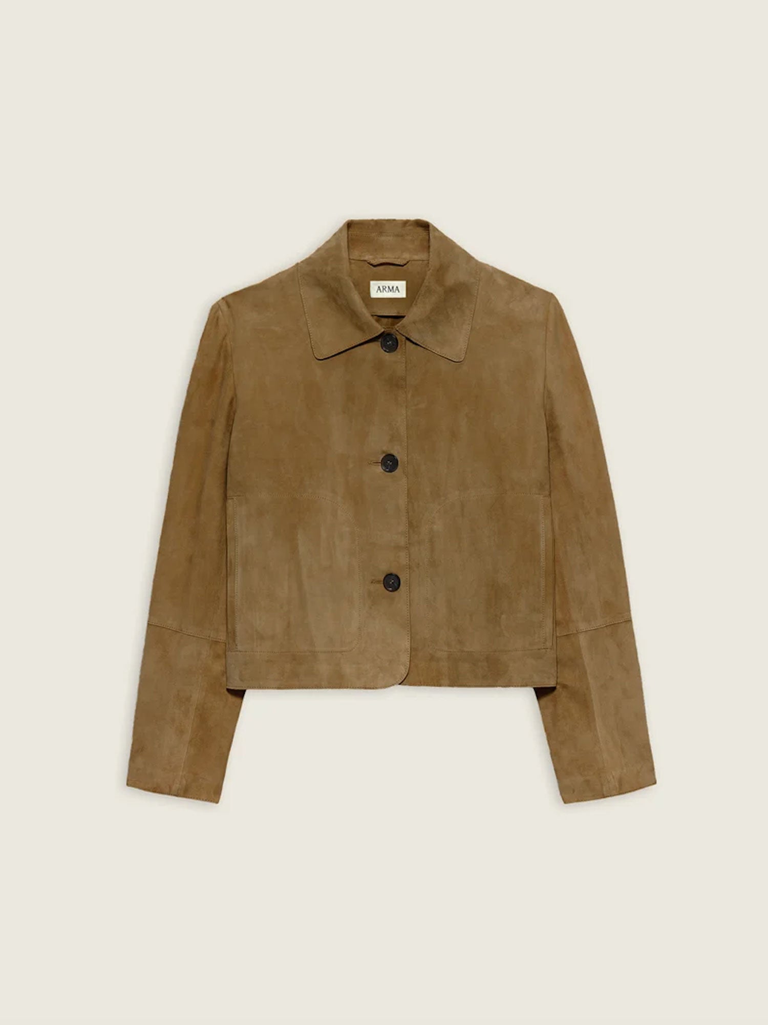 A cropped suede jacket in a warm camel brown color, featuring a pointed collar, three dark buttons down the front, and long sleeves, shown flat against a light cream background.
