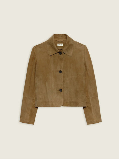 A cropped suede jacket in a warm camel brown color, featuring a pointed collar, three dark buttons down the front, and long sleeves, shown flat against a light cream background.