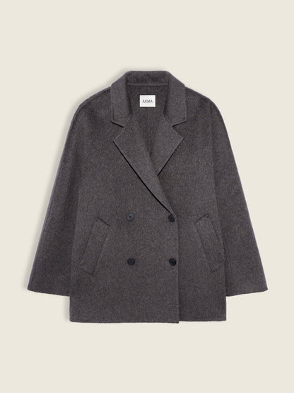 A dark gray double-breasted wool-blend blazer jacket with a notched lapel and front buttons, shown flat against a light beige background.