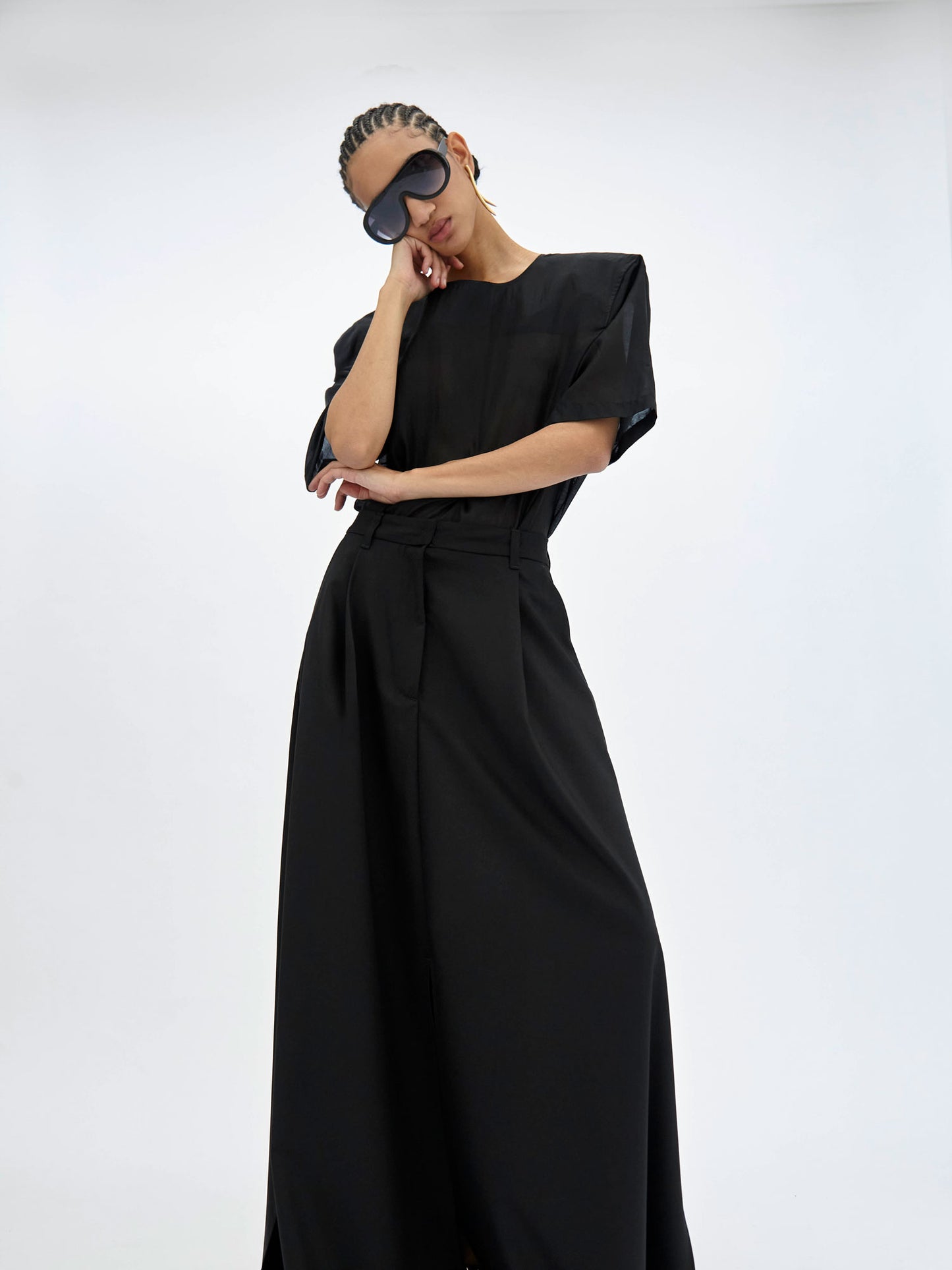 Woman wearing a black top with a plain background