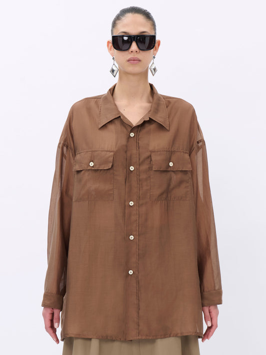 Person wearing a brown button-up shirt on a white background