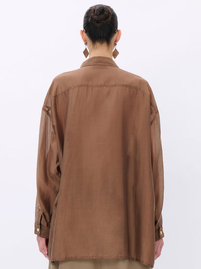 Person wearing a brown jacket on a white background