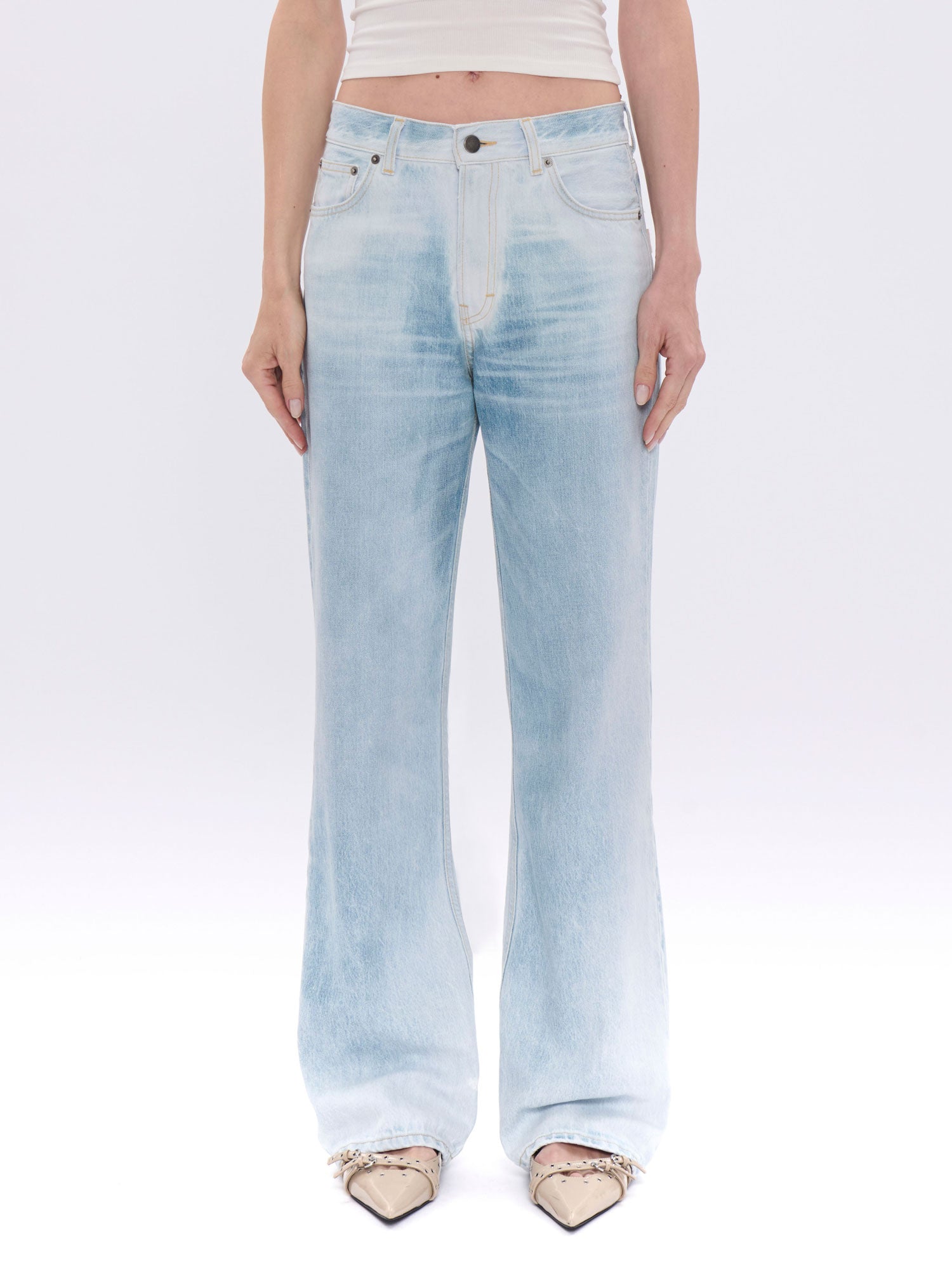 Light blue jeans worn by a person on a white background