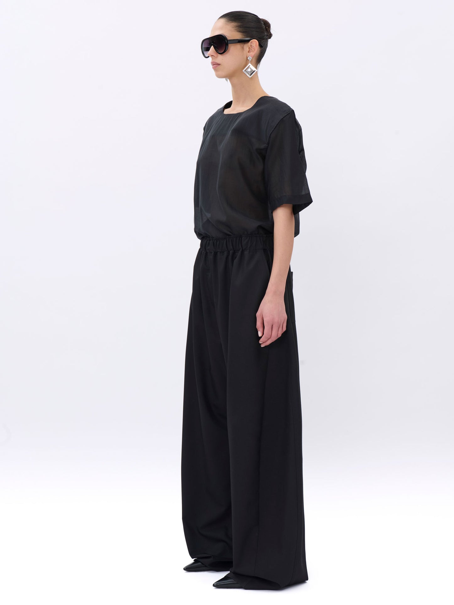 Woman wearing a black outfit on a white background