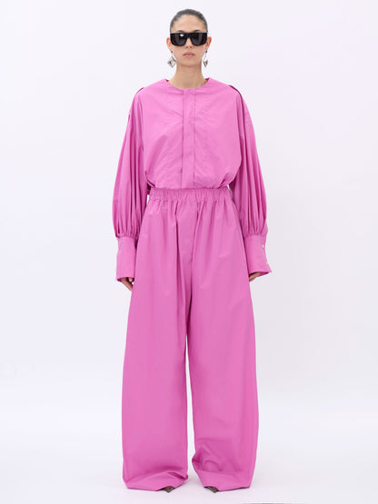 Person wearing a pink shirt on a white background